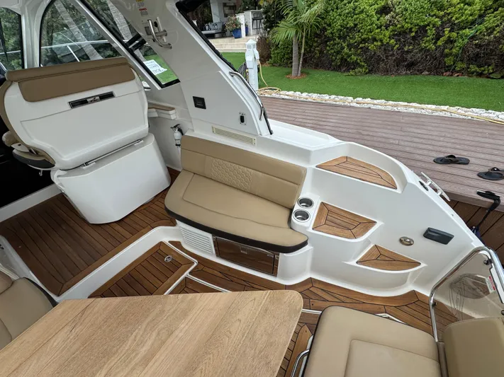 Idylwilde Yacht Photos Pics Interior of 2018 Sea Ray Sundancer 350 Coupe with tan seating and wooden flooring.
