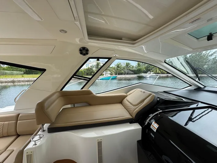 Idylwilde Yacht Photos Pics 2018 Sea Ray Sundancer 350 Coupe interior with luxurious seating and scenic water view.