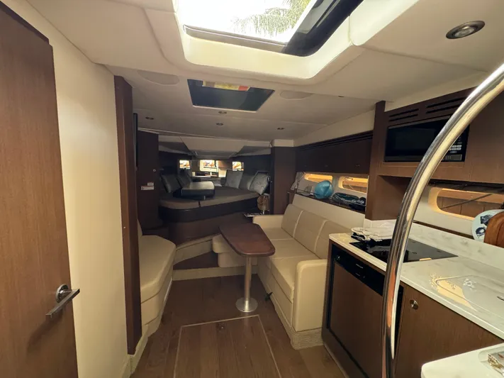 Idylwilde Yacht Photos Pics Interior of 2018 Sea Ray Sundancer 350 Coupe, featuring modern kitchen and seating area.