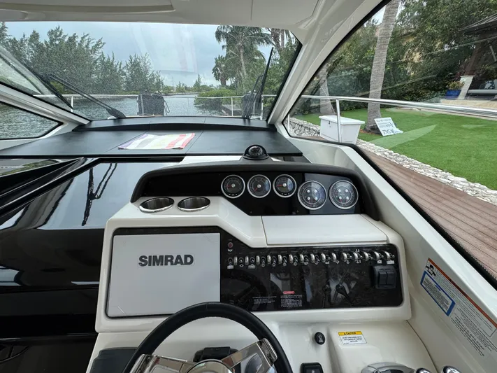 Idylwilde Yacht Photos Pics Cockpit view of 2018 Sea Ray Sundancer 350 Coupe with Simrad navigation system.