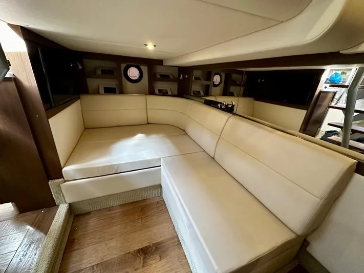 Idylwilde Yacht Photos Pics Luxurious interior of 2018 Sea Ray Sundancer 350 Coupe with beige seating and wood accents.