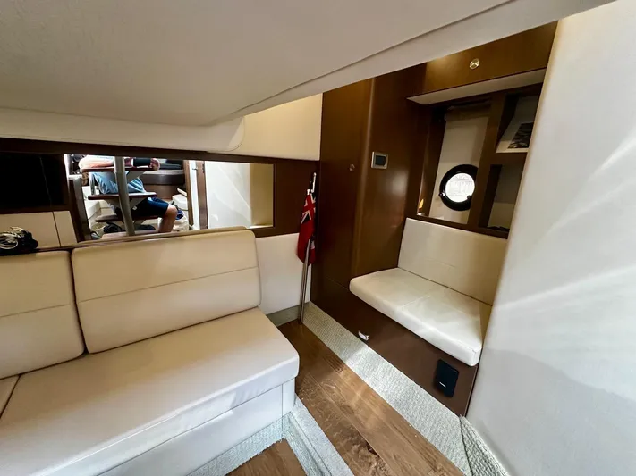 Idylwilde Yacht Photos Pics Interior of 2018 Sea Ray Sundancer 350 Coupe with beige seating and wooden accents.