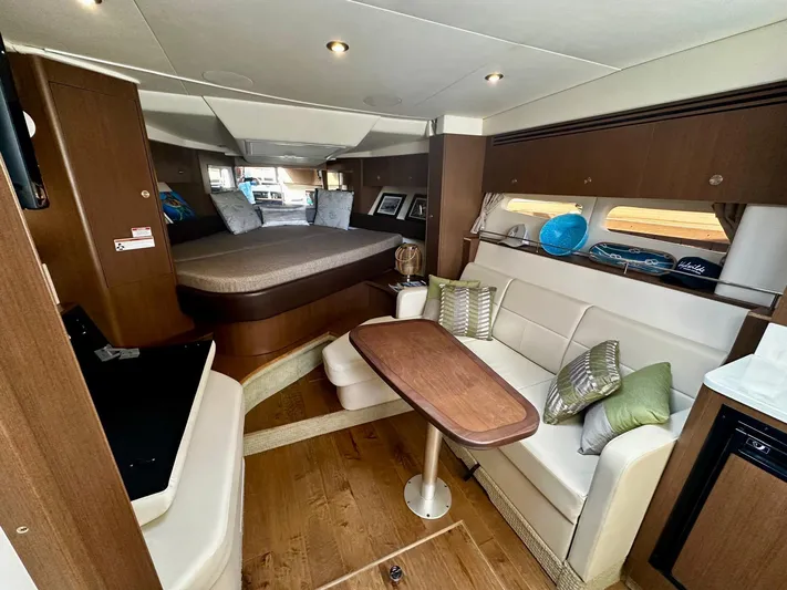 Idylwilde Yacht Photos Pics 2018 Sea Ray Sundancer 350 Coupe interior with cozy seating, dining table, and modern design.
