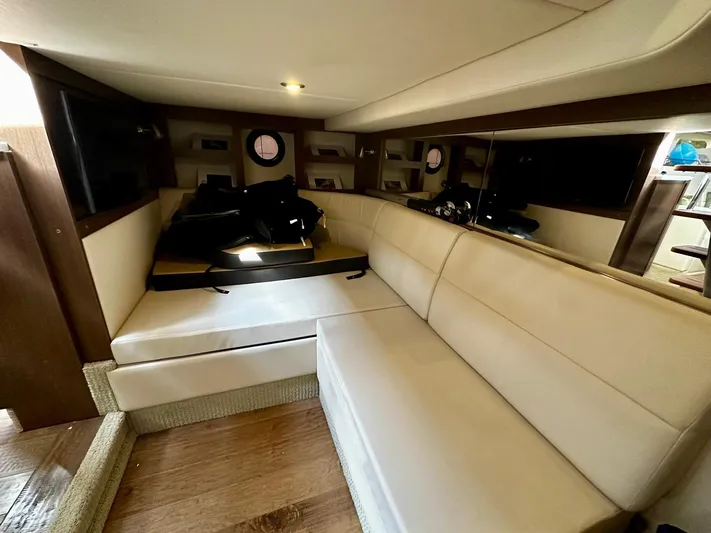 Idylwilde Yacht Photos Pics 2018 Sea Ray Sundancer 350 Coupe interior with beige seating and wooden flooring.