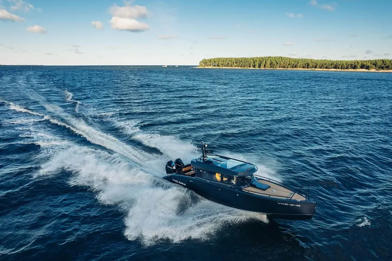  Yacht Photos Pics 2026 XO Boats EXPLR 10S PLUS cruising on open water under a clear sky.