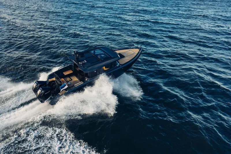  Yacht Photos Pics 2026 XO Boats EXPLR 10S PLUS cruising on open water, showcasing sleek design and performance.