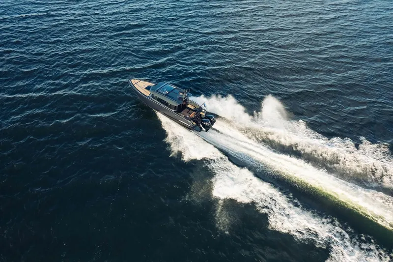  Yacht Photos Pics 2026 XO Boats EXPLR 10S PLUS speeding on open water, aerial view.