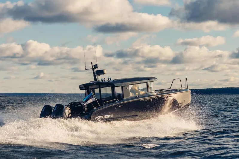  Yacht Photos Pics 2026 XO Boats EXPLR 10S PLUS navigating through waves under a cloudy sky.