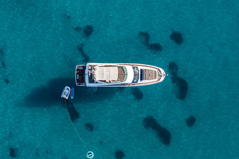 Yacht Photos Pics Aerial view of 2016 Prestige 680 yacht on clear blue water.