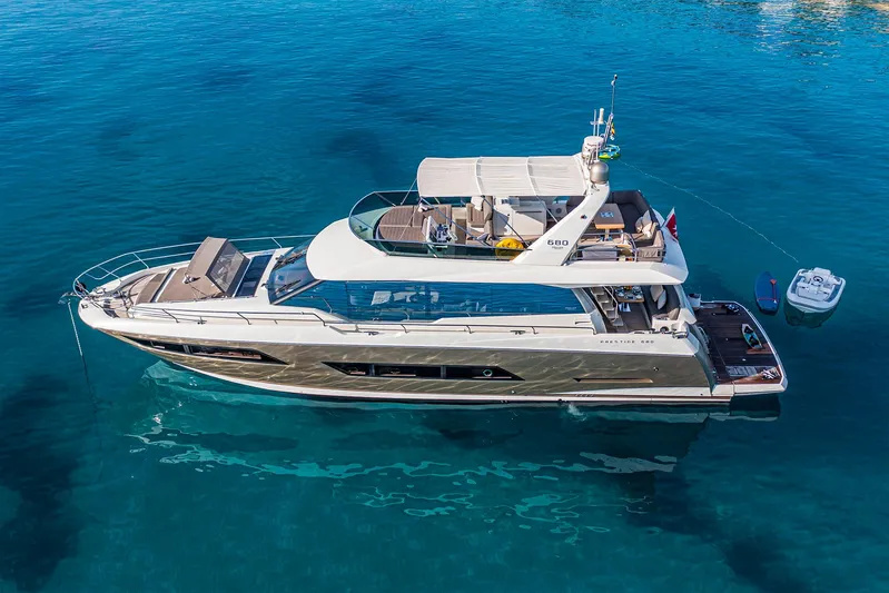  Yacht Photos Pics Luxurious 2016 Prestige 680 yacht anchored in clear blue water.