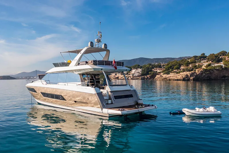  Yacht Photos Pics Luxury 2016 Prestige 680 yacht anchored in serene coastal waters.