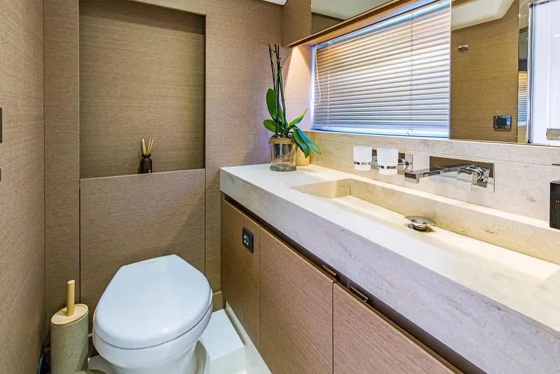  Yacht Photos Pics Luxurious bathroom in a 2016 Prestige 680 yacht with modern fixtures and elegant design.