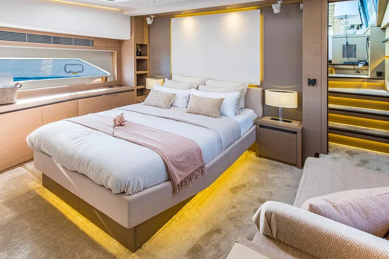  Yacht Photos Pics Luxurious bedroom interior on a 2016 Prestige 680 yacht, featuring modern design and ambient lighting.