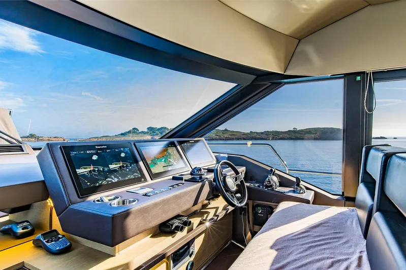  Yacht Photos Pics Interior view of 2016 Prestige 680 yacht helm with navigation screens and ocean view.
