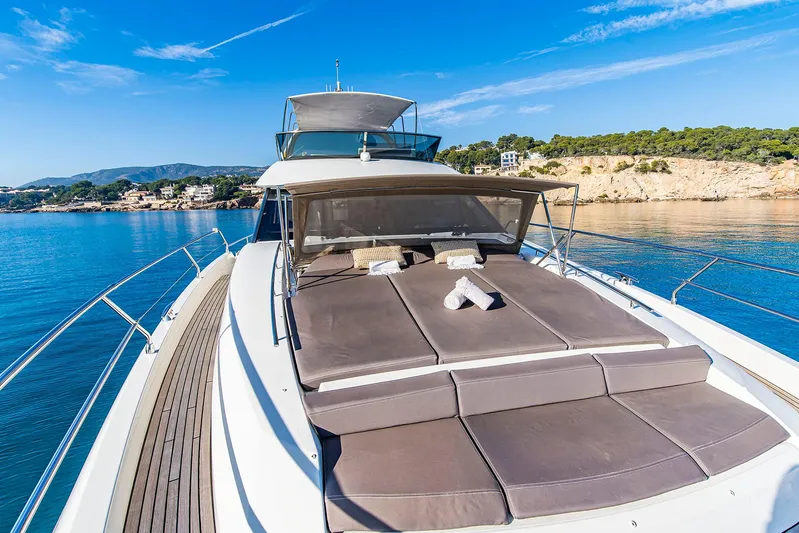  Yacht Photos Pics Luxury 2016 Prestige 680 yacht with sunbathing deck, cruising on serene blue waters.