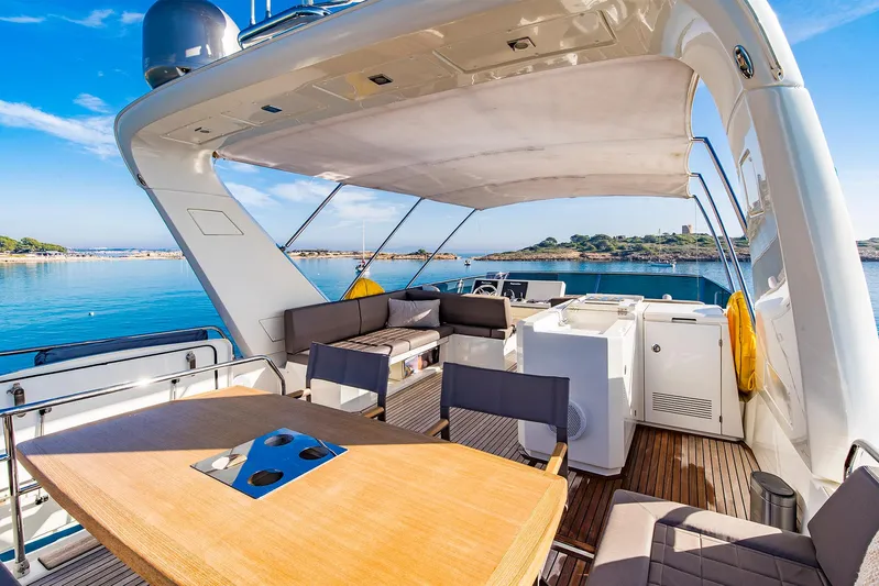  Yacht Photos Pics Luxurious 2016 Prestige 680 yacht deck with seating, table, and ocean view.