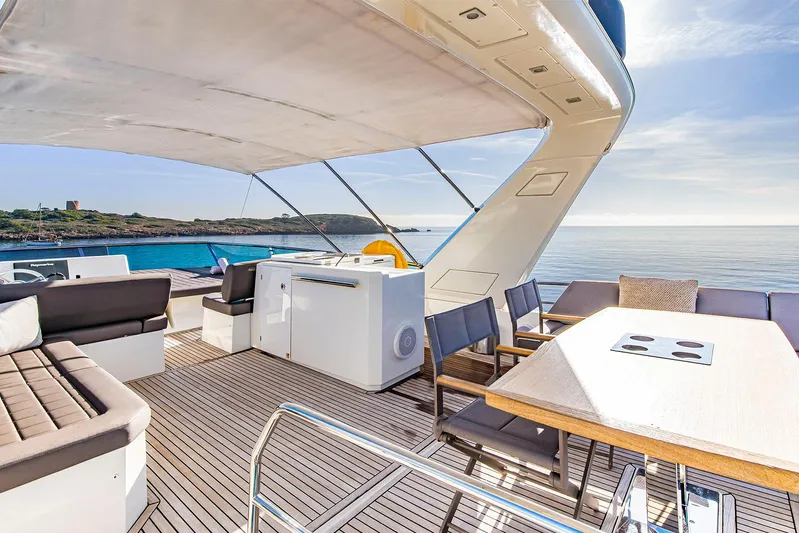  Yacht Photos Pics Luxurious 2016 Prestige 680 yacht deck with seating, dining area, and ocean view.