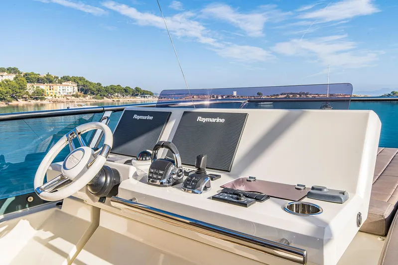  Yacht Photos Pics Luxury yacht helm with Raymarine navigation, Prestige 680, 2016 model, scenic coastal view.