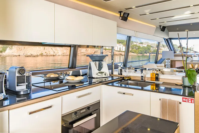  Yacht Photos Pics Luxurious kitchen interior on a 2016 Prestige 680 yacht with modern appliances and scenic views.