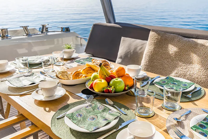  Yacht Photos Pics Luxurious dining setup on a 2016 Prestige 680 yacht, featuring fresh fruit and ocean view.