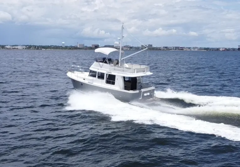 Amour Yacht Photos Pics 2018 Beneteau Swift Trawler 34 cruising on open water under a cloudy sky.