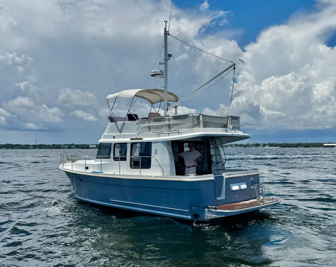 Amour Yacht Photos Pics 2018 Beneteau Swift Trawler 34 cruising on open water under a cloudy sky.