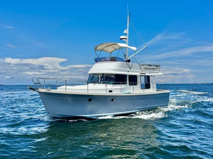 Amour Yacht Photos Pics 2018 Beneteau Swift Trawler 34 cruising on open water under a clear blue sky.