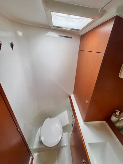 Amour Yacht Photos Pics 2018 Beneteau Swift Trawler 34 bathroom with wooden cabinets and skylight.