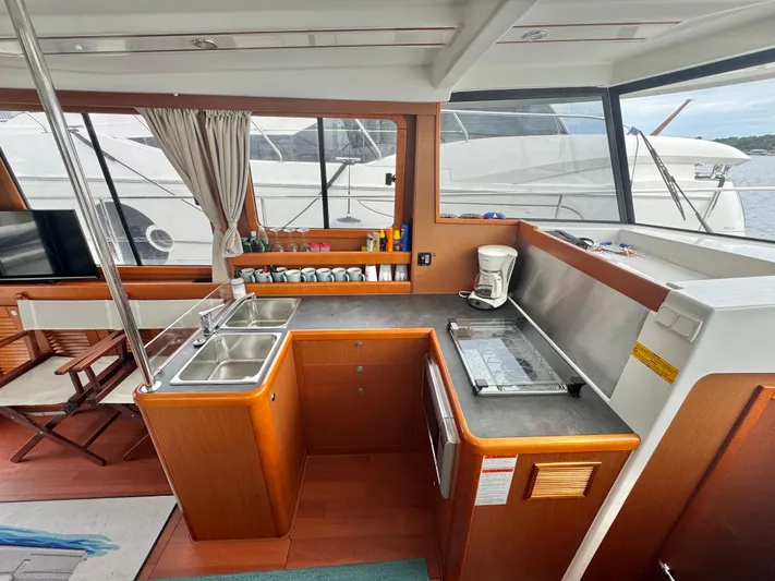 Amour Yacht Photos Pics 2018 Beneteau Swift Trawler 34 interior kitchen with sink, counter, and window view.