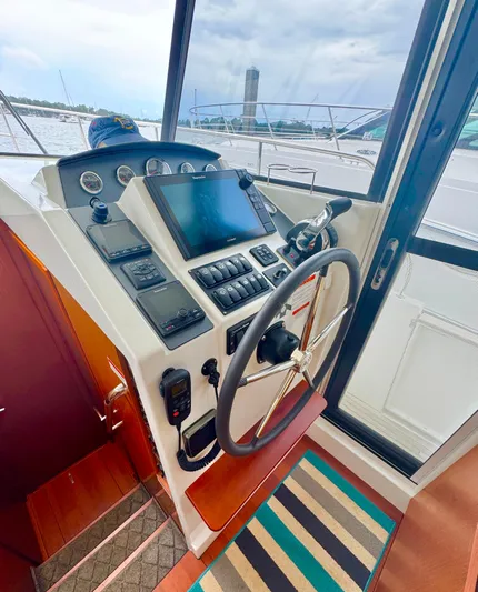 Amour Yacht Photos Pics 2018 Beneteau Swift Trawler 34 helm with navigation controls and steering wheel.