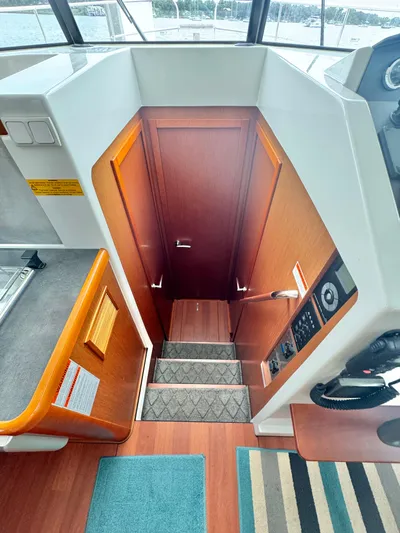Amour Yacht Photos Pics Interior view of 2018 Beneteau Swift Trawler 34, featuring wooden stairs and modern design.