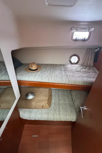 Amour Yacht Photos Pics Cabin interior of 2018 Beneteau Swift Trawler 34 with bunk beds and a small window.