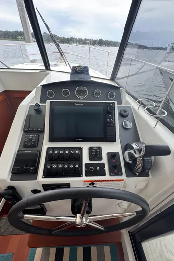 Amour Yacht Photos Pics Helm of 2018 Beneteau Swift Trawler 34 with navigation controls and steering wheel.