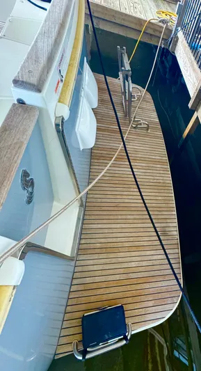 Amour Yacht Photos Pics 2018 Beneteau Swift Trawler 34 with wooden deck, docked at marina.