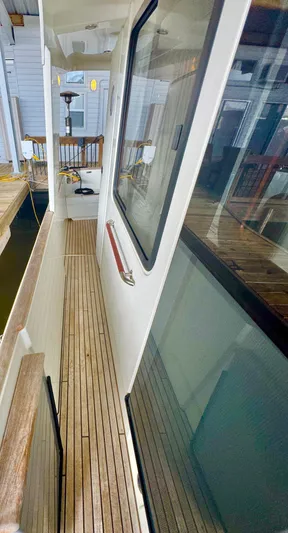 Amour Yacht Photos Pics 2018 Beneteau Swift Trawler 34 side deck with wooden flooring and railing.