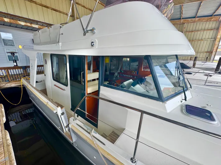 Amour Yacht Photos Pics 2018 Beneteau Swift Trawler 34 docked in a covered marina.