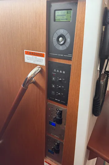Amour Yacht Photos Pics Control panel of a 2018 Beneteau Swift Trawler 34 with warning label and wooden finish.