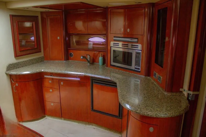 Flingstone 2006 Sea Ray 40 Da Yacht Photos Pics Luxurious kitchen interior of 2006 Sea Ray 40 Sundancer yacht with wood cabinetry and modern appliances.