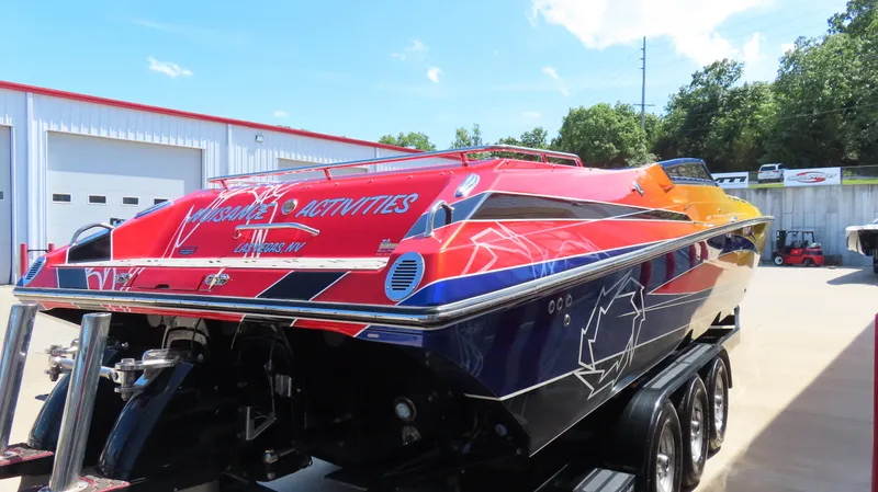  Yacht Photos Pics 2007 Fountain 42 Lightning speedboat with vibrant graphics on a trailer.