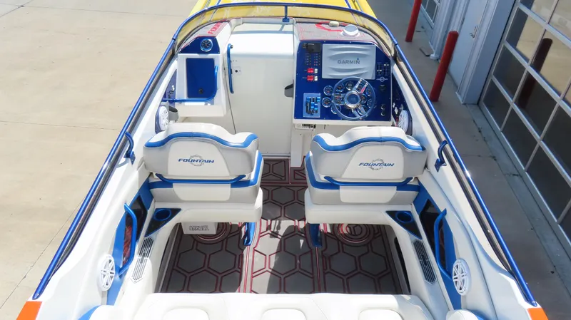  Yacht Photos Pics 2007 Fountain 42 Lightning boat interior with blue and white seating, advanced dashboard controls.