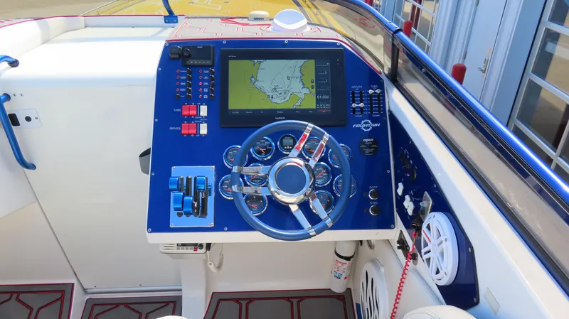  Yacht Photos Pics 2007 Fountain 42 Lightning boat dashboard with navigation screen and controls.