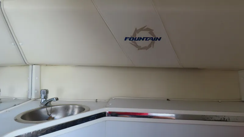  Yacht Photos Pics Interior of 2007 Fountain 42 Lightning boat with sink and logo on wall.
