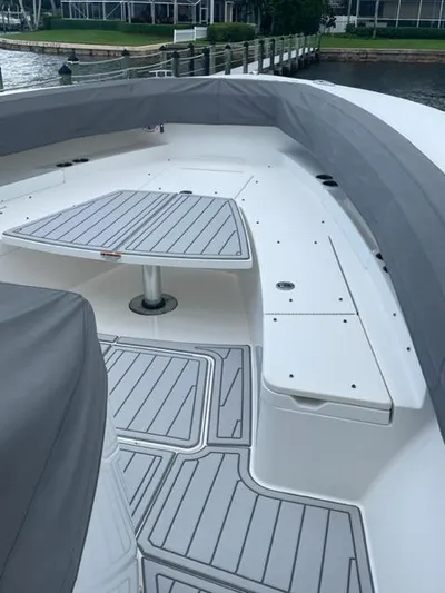  Yacht Photos Pics 2018 Regulator 41 boat deck with seating and table, docked by the water.