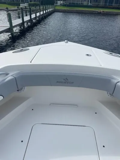  Yacht Photos Pics 2018 Regulator 41 boat bow with seating, docked by a wooden pier.