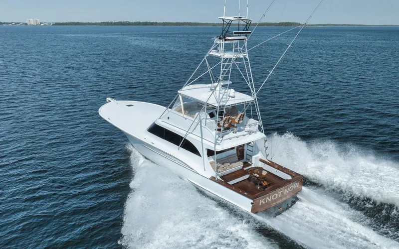 Knot Now Yacht Photos Pics 1997 Miller Marine Custom Carolina yacht cruising on open water, rear view.