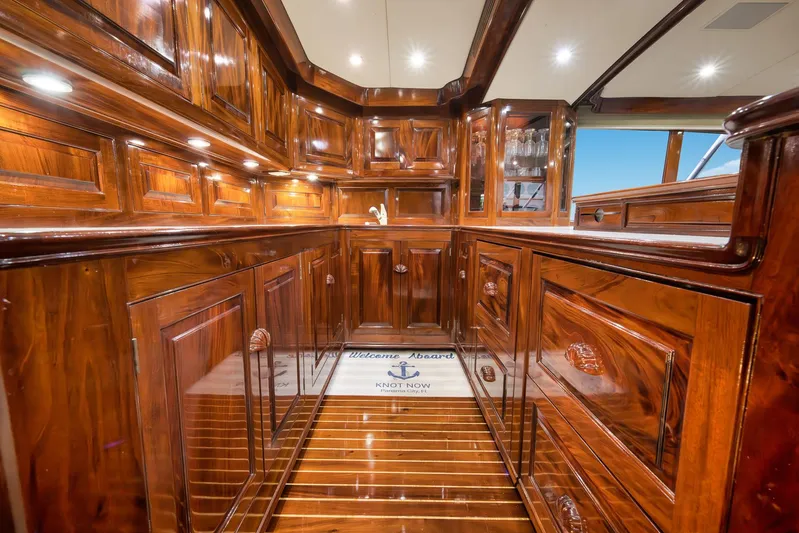 Knot Now Yacht Photos Pics Luxurious wooden interior of a 1997 Miller Marine Custom Carolina yacht with polished cabinetry.