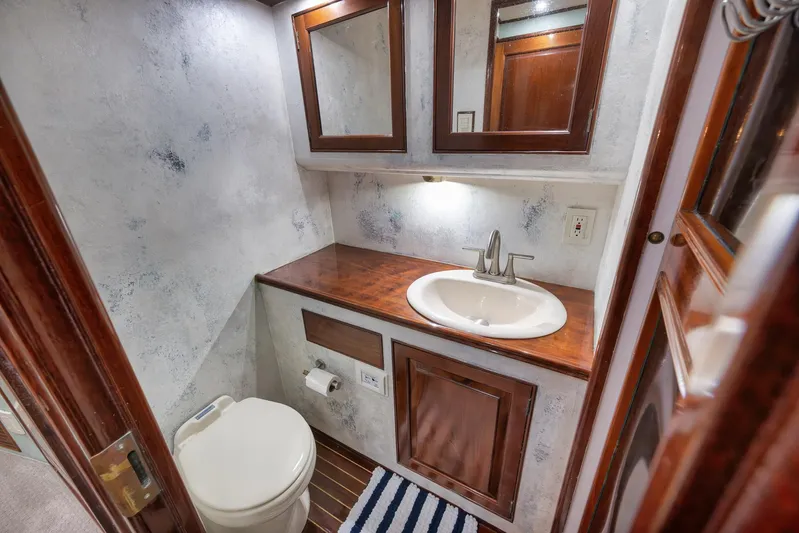 Knot Now Yacht Photos Pics Luxurious 1997 Miller Marine Custom Carolina bathroom with wood accents and modern fixtures.