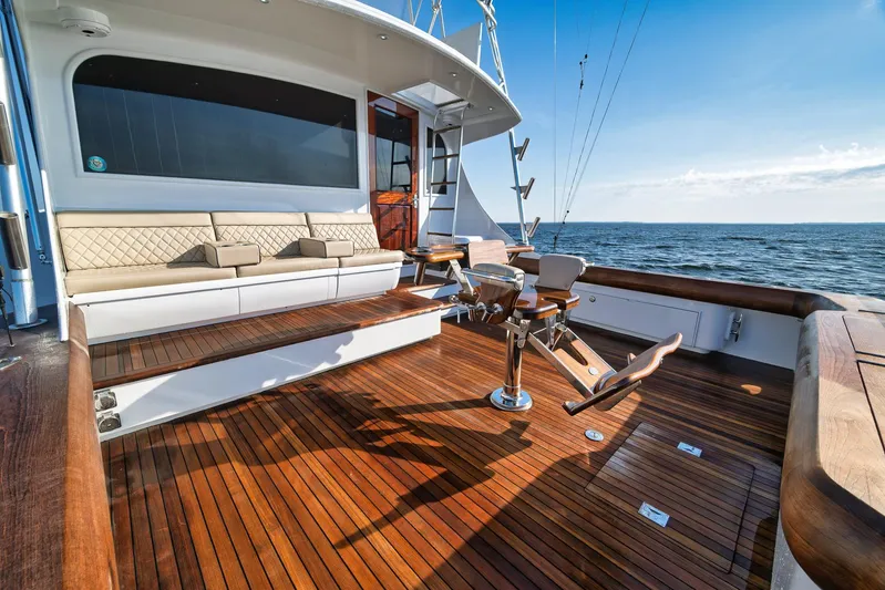 Knot Now Yacht Photos Pics Luxurious 1997 Miller Marine Custom Carolina yacht deck with seating, overlooking the ocean.