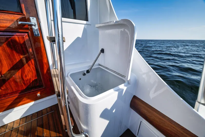 Knot Now Yacht Photos Pics Open hatch on 1997 Miller Marine Custom Carolina boat, overlooking ocean.