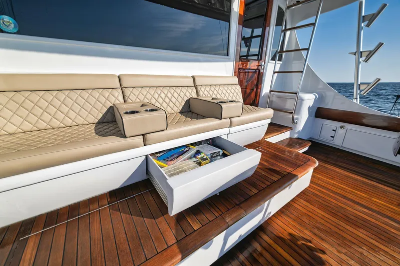 Knot Now Yacht Photos Pics Luxurious 1997 Miller Marine Custom Carolina yacht with cushioned seating and wooden deck.